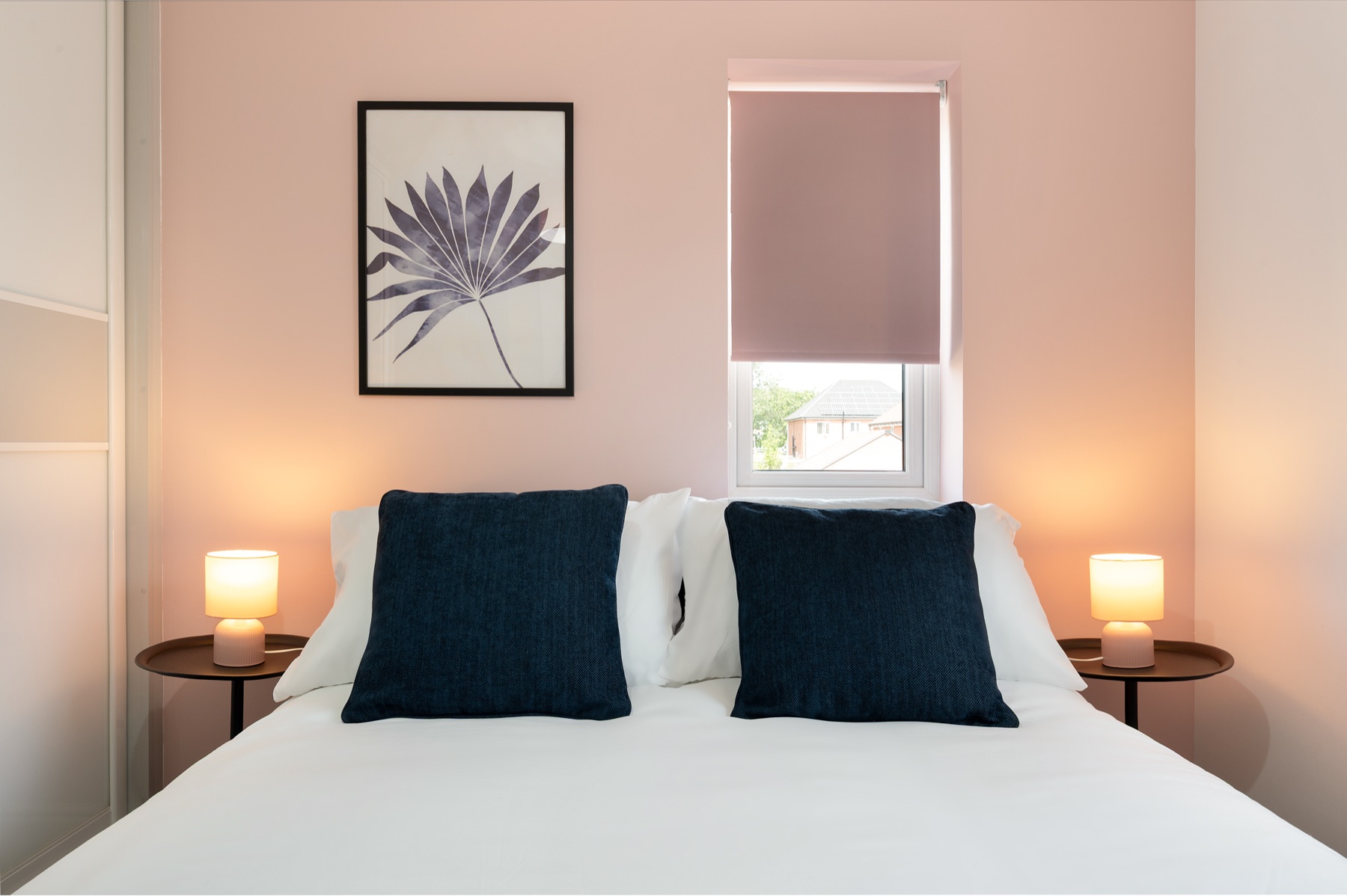 Loddon Lodge double bed with navy cushions