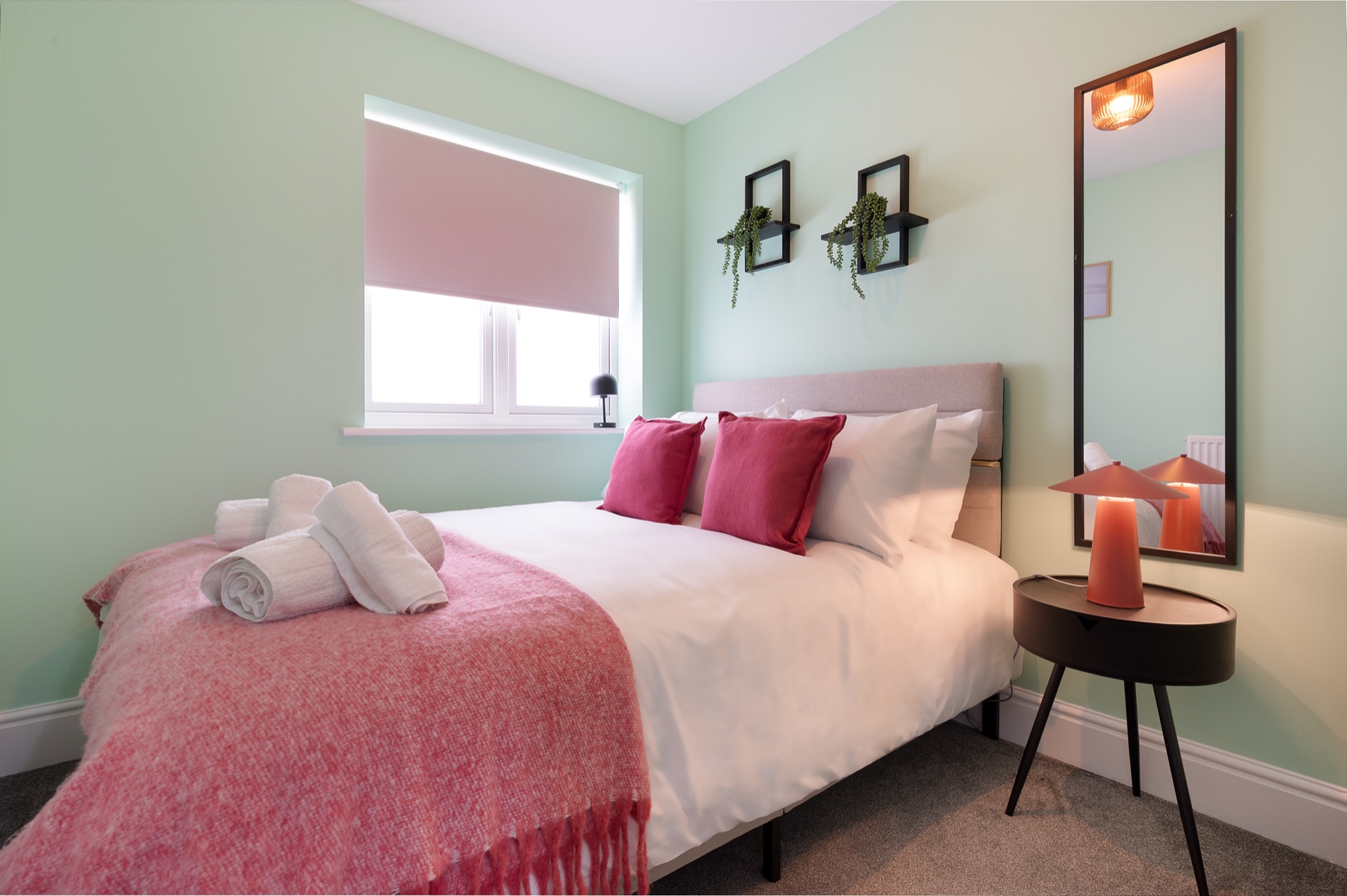 Loddon Lodge double bedroom with pink throw